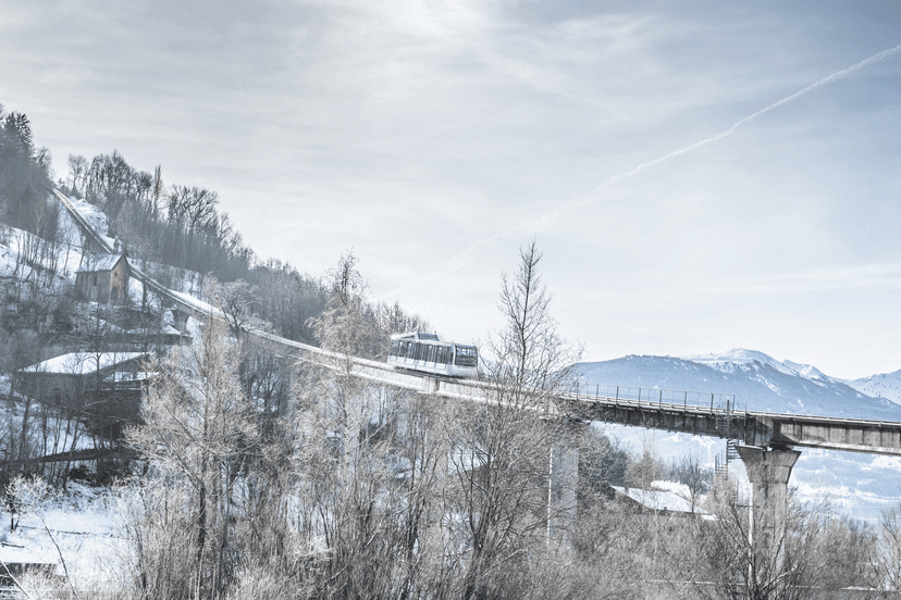 Ski lift transporting passengers to top of Alps mountain